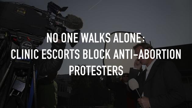 No One Walks Alone: Clinic Escorts Block Anti-Abortion Protesters